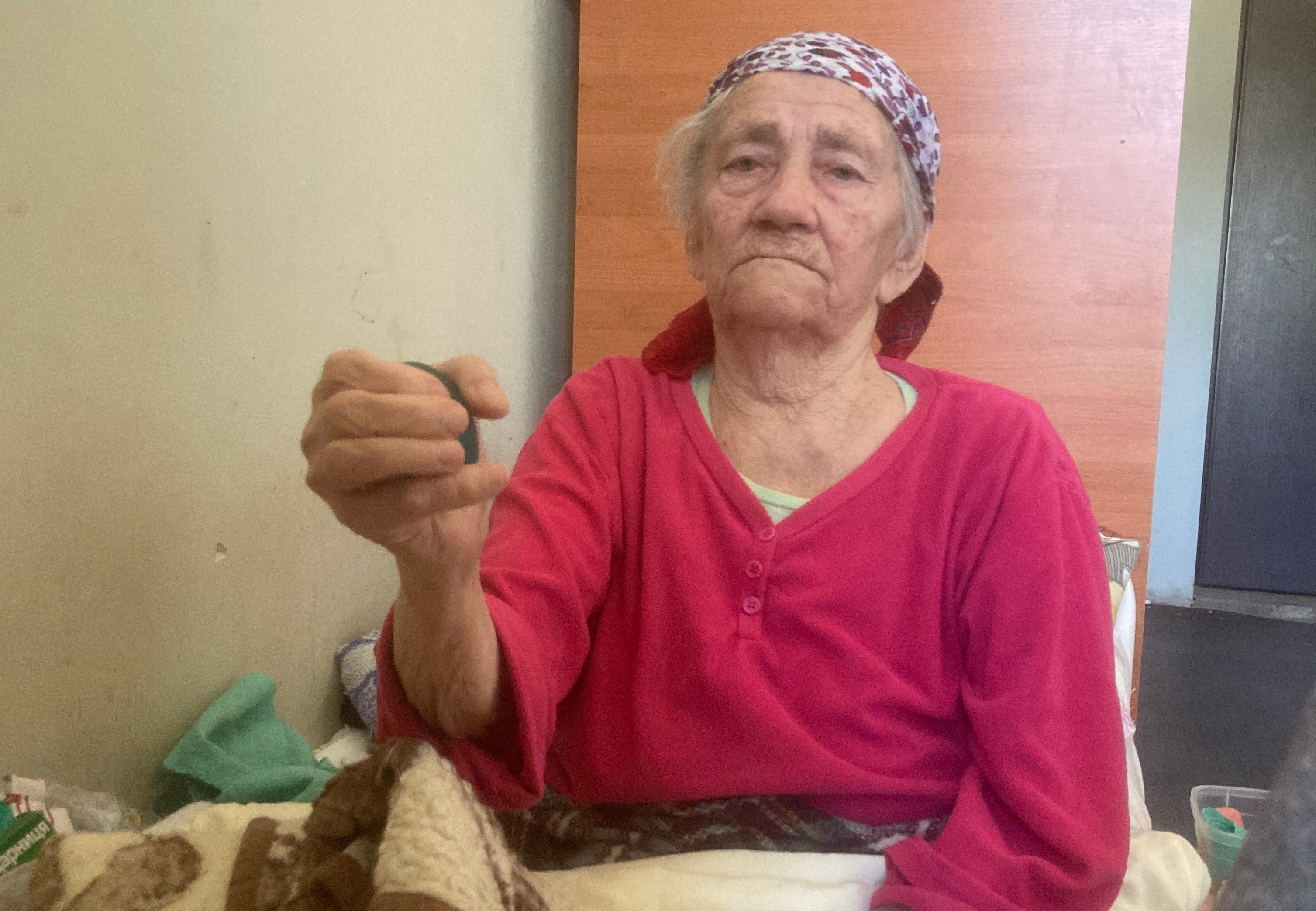 Vera squeezes a ball to strengthen her fingers.